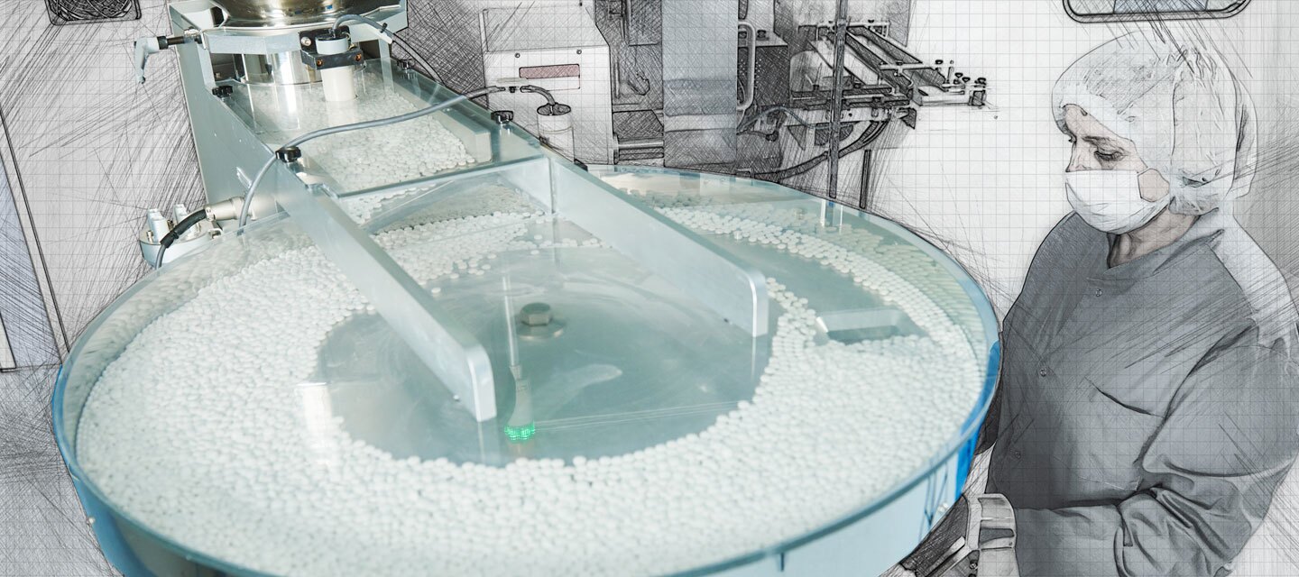 Worker in mask visually inspecting pill manufacturing process