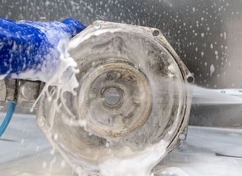 Spray gun parts washing of metal component