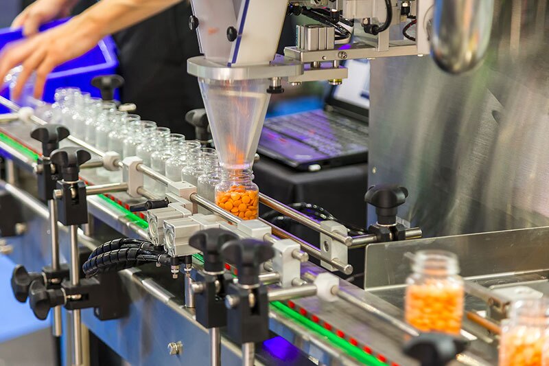 Medicine being bottled on pharmaceutical manufacturing line