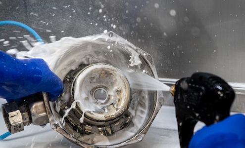 Parts being washed with spray gun