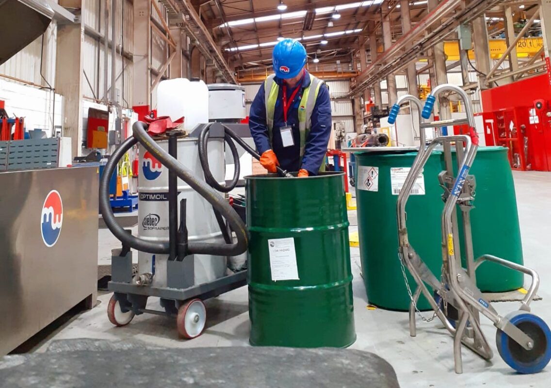 Metalwash technician servicing a machine at customers