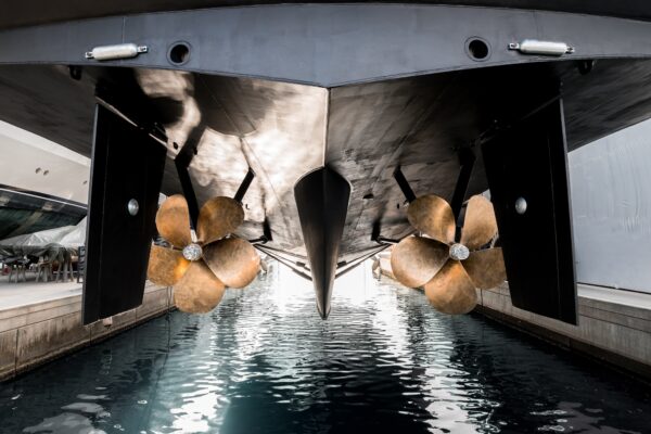 Superyacht being lowered into the water after winter haul out at shipyard.